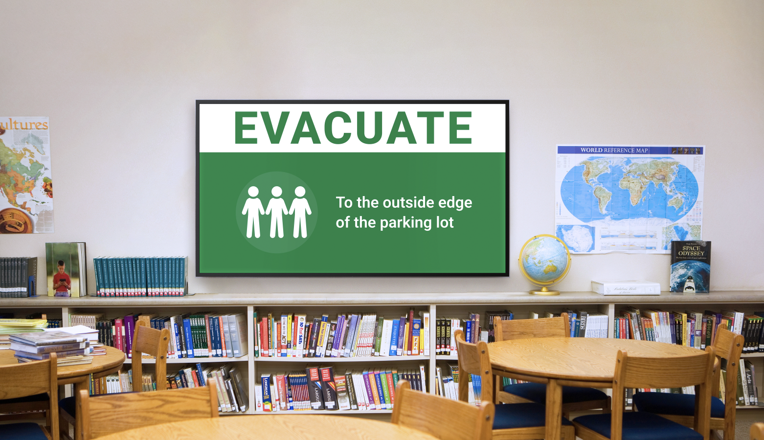 A school library with emergency alert displayed on screen.